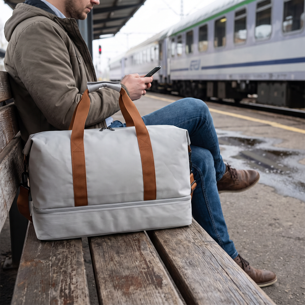 Weekender Duffle Bag (Grey) on a train station platform