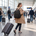 Black multi-purpose travel backpack worn walking through an airport