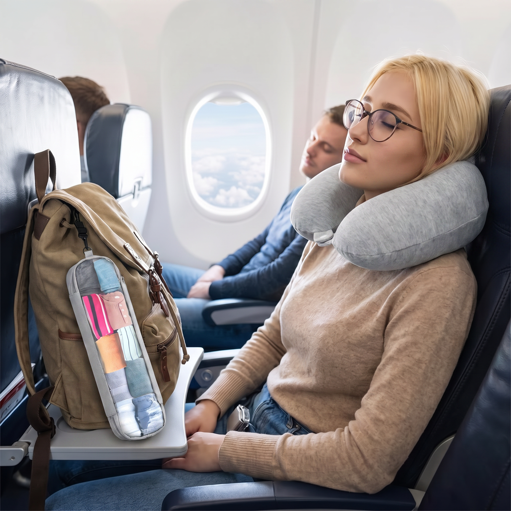 Light grey neck pillow with travel pouch in real-life use