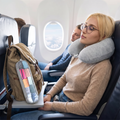 Light grey neck pillow with travel pouch in real-life use